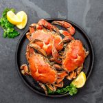 Cooked Crabs on Black Plate Served With White Wine, Black Slate Background